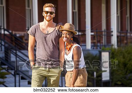 Laughing couple walking outdoors View Large Photo Image Stock Image - Laughing couple walking outdoors. Fotosearch