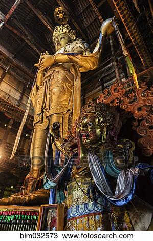 Low angle view of ornate Buddhist statue in temple View Large Photo Image Stock Image - Low angle view of ornate Buddhist statue in temple. Fotosearch