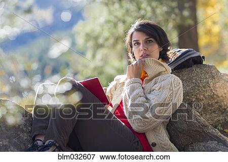 Mixed race hiker reading in forest View Large Photo Image Stock Photo - Mixed race hiker reading in forest. Fotosearch