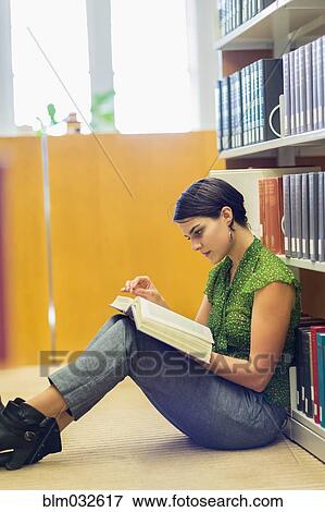 Mixed race student reading book in library View Large Photo Image Stock Photo - Mixed race student reading book in library. Fotosearch