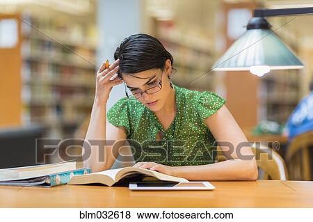 Mixed race student studying in library View Large Photo Image Stock Photo - Mixed race student studying in library. Fotosearch