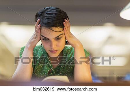 Mixed race student studying in library View Large Photo Image Stock Photo - Mixed race student studying in library. Fotosearch