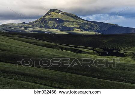Mountain over rolling hills in rural landscape View Large Photo Image Stock Photo - Mountain over rolling hills in rural landscape. Fotosearch