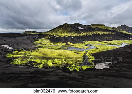 Stock Photograph - Mountain, rock formations and river in remote landscape. Fotosearch