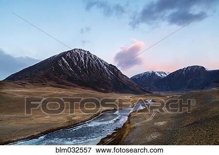 Stock Photo - Mountains over river in remote landscape. Fotosearch