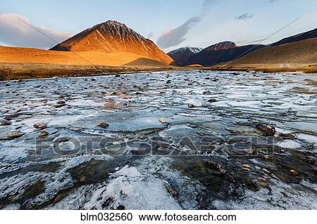 Mountains over rocky river in remote landscape View Large Photo Image Stock Image - Mountains over rocky river in remote landscape. Fotosearch