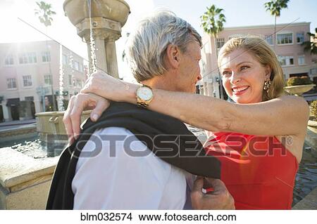 Older Caucasian couple hugging near fountain View Large Photo Image Picture - Older Caucasian couple hugging near fountain. Fotosearch