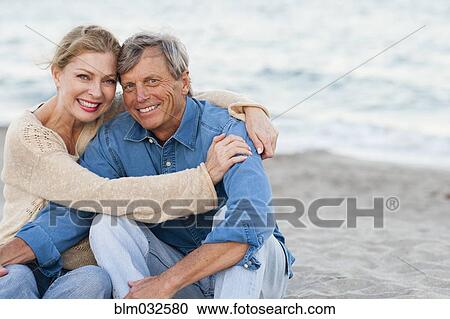 Older Caucasian couple hugging on beach View Large Photo Image Stock Image - Older Caucasian couple hugging on beach. Fotosearch