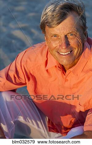 Older Caucasian man smiling on beach View Large Photo Image Stock Photo - Older Caucasian man smiling on beach. Fotosearch