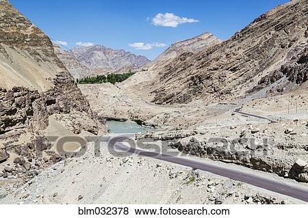 Remote road in rocky mountain valley View Large Photo Image Stock Photo - Remote road in rocky mountain valley. Fotosearch
