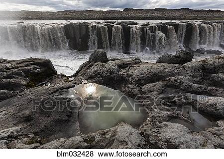 Rock formations over Sellfoss Falls and river, Myvatn, Iceland View Large Photo Image Stock Photo - Rock formations over Sellfoss Falls and river, Myvatn, Iceland. Fotosearch