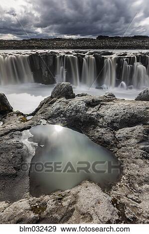 Rock formations over Sellfoss Falls and river, Myvatn, Iceland View Large Photo Image Stock Photo - Rock formations over Sellfoss Falls and river, Myvatn, Iceland. Fotosearch