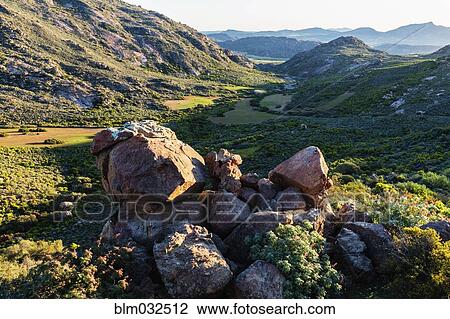 Rocks in grassy field in remote landscape View Large Photo Image Stock Image - Rocks in grassy field in remote landscape. Fotosearch