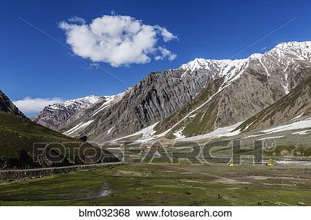 Snow covered mountains over rocky canyon road View Large Photo Image Stock Photo - Snow covered mountains over rocky canyon road. Fotosearch