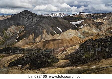 Snowy mountains and rhyolite formations in remote landscape View Large Photo Image Stock Photography - Snowy mountains and rhyolite formations in remote landscape. Fotosearch