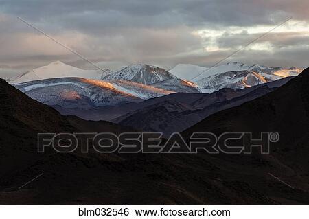 Snowy mountains in remote landscape at dusk View Large Photo Image Stock Photograph - Snowy mountains in remote landscape at dusk. Fotosearch