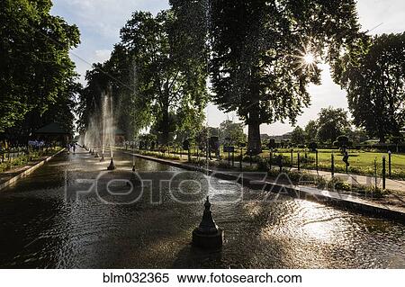 Spraying fountains in park pond View Large Photo Image Stock Photography - Spraying fountains in park pond. Fotosearch