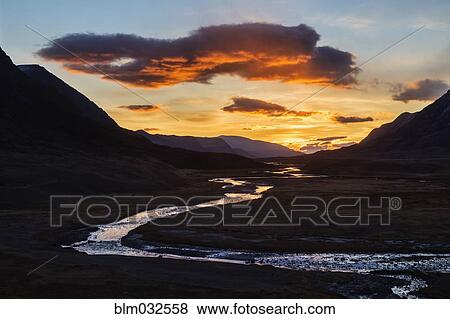 Sunset sky over river and remote mountain landscape View Large Photo Image Stock Photo - Sunset sky over river and remote mountain landscape. Fotosearch