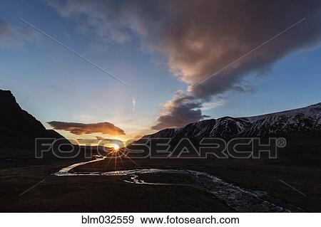 Sunset sky over river and remote mountain landscape View Large Photo Image Stock Photo - Sunset sky over river and remote mountain landscape. Fotosearch