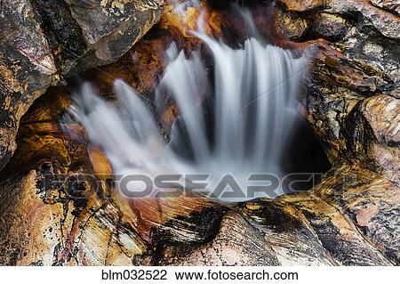 Time lapse view of waterfall flowing into rock formations View Large Photo Image Stock Image - Time lapse view of waterfall flowing into rock formations. Fotosearch
