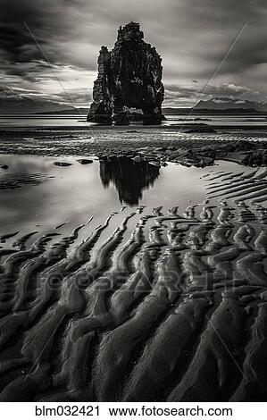 Stock Image - Water pooling on beach near Hvitserkur Rock, Hvammstangi, Iceland. Fotosearch