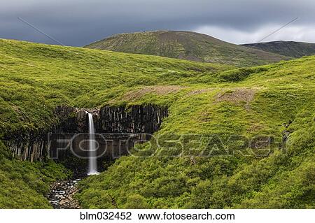 Waterfall in rolling hills in remote landscape View Large Photo Image Stock Image - Waterfall in rolling hills in remote landscape. Fotosearch