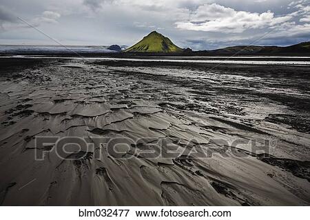 Stock Photo - Wet sand and mountain on arctic beach. Fotosearch