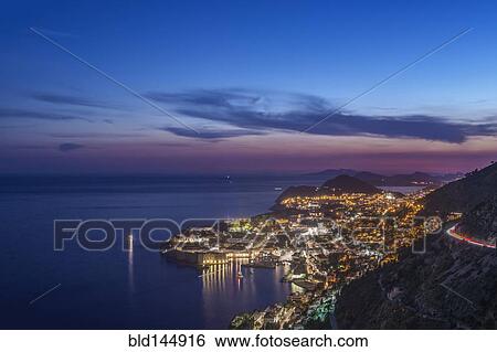 Stock Photograph - Aerial view of coastal city illuminated at night, Dubrovnik, Dubrovnik-Neretva, Croatia. Fotosearch