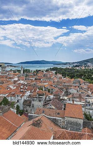 Aerial view of coastal city rooftops under cloudy sky, Trogir, Split, Croatia View Large Photo Image Stock Image - Aerial view of coastal city rooftops under cloudy sky, Trogir, Split, Croatia. Fotosearch