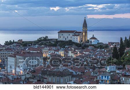 Stock Image - Aerial view of village buildings near lake. Fotosearch