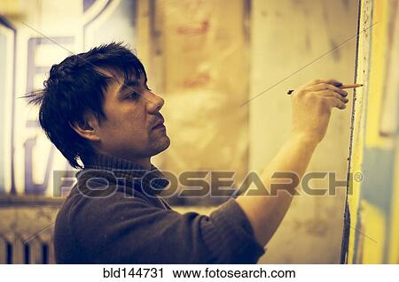 Asian artist drawing on canvas in studio View Large Photo Image Stock Image - Asian artist drawing on canvas in studio. Fotosearch