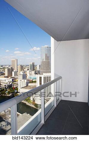 Balcony overlooking high rises in urban cityscape, Miami, Florida, United States View Large Photo Image Picture - Balcony overlooking high rises in urban cityscape, Miami, Florida, United States. Fotosearch