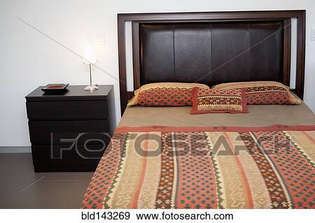 Bed and side table in modern bedroom View Large Photo Image Stock Photo - Bed and side table in modern bedroom. Fotosearch
