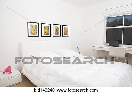 Bed and wall art in modern bedroom View Large Photo Image Stock Image - Bed and wall art in modern bedroom. Fotosearch