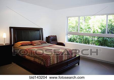 Picture - Bed, night table and window in modern bedroom. Fotosearch