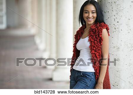 Stock Photo - Black woman leaning on pillar. Fotosearch