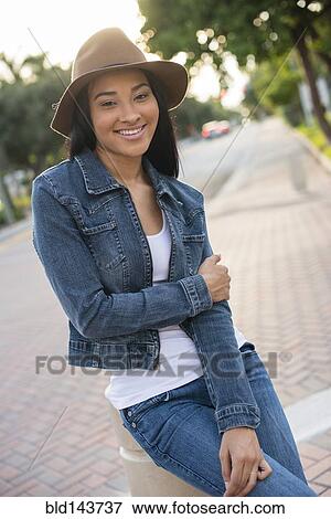 Black woman sitting on pillar View Large Photo Image Stock Photo - Black woman sitting on pillar. Fotosearch