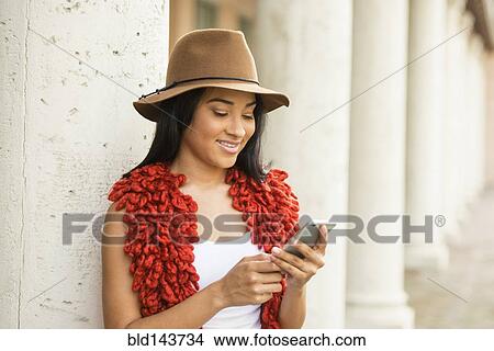 Black woman using cell phone outdoors View Large Photo Image Picture - Black woman using cell phone outdoors. Fotosearch