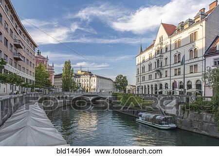 Buildings and pedestrian bridge over urban canal, Ljubljana, Central Slovenia, Slovenia View Large Photo Image Picture - Buildings and pedestrian bridge over urban canal, Ljubljana, Central Slovenia, Slovenia. Fotosearch