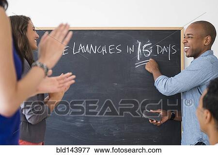 Stock Photo - Business people cheering and preparing for launch in office. Fotosearch