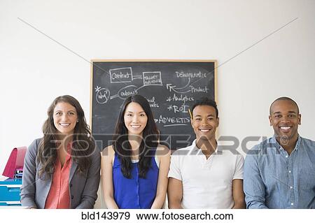 Stock Photo - Business people smiling in office. Fotosearch