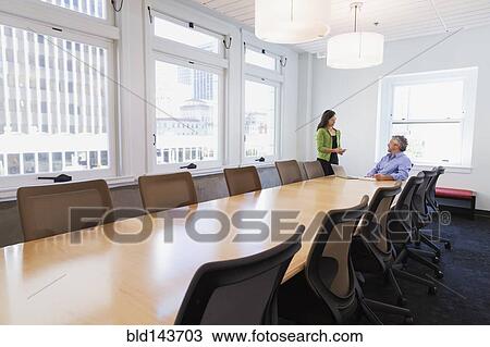 Stock Image - Business people talking in conference room. Fotosearch