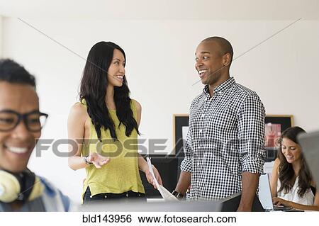 Stock Photograph - Business people talking in office. Fotosearch