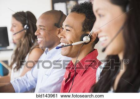Business people wearing headsets in office View Large Photo Image Stock Image - Business people wearing headsets in office. Fotosearch