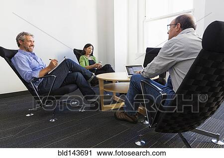 Business people working together in office View Large Photo Image Stock Image - Business people working together in office. Fotosearch