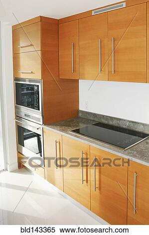 Stock Photography - Cabinets, counters and stove in modern kitchen. Fotosearch