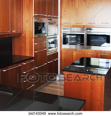 Stock Photo - Cabinets, oven and counters in modern kitchen. Fotosearch