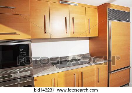 Stock Photo - Cabinets, stove and countertop in modern kitchen. Fotosearch