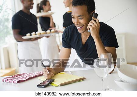 Caterer talking on phone in event space View Large Photo Image Stock Image - Caterer talking on phone in event space. Fotosearch