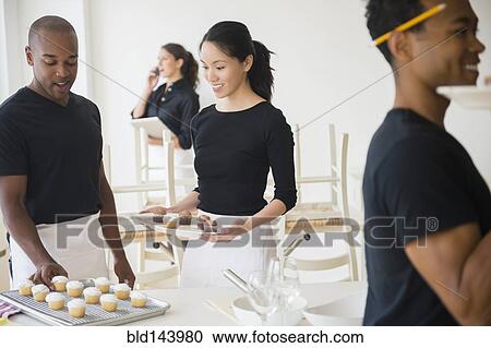 Caterers working together in event space View Large Photo Image Stock Image - Caterers working together in event space. Fotosearch